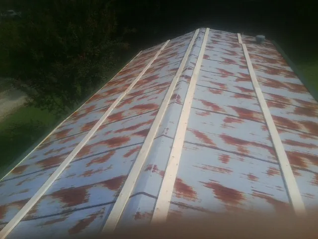 Rusted metal roof panels with new wood purlins before replacement — Storm Damage Roof Repair in Hammonton by Roofing Brothers