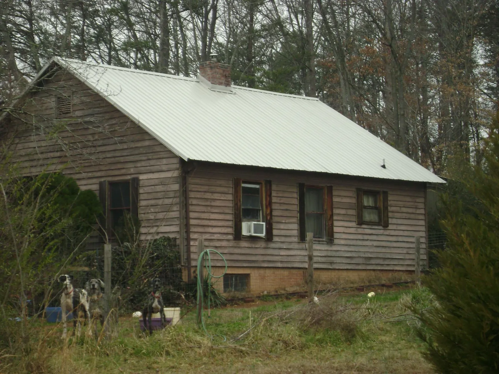 White metal roof on an old wood sided farmhouse, from a Metal Roof Installation job in Hammonton
